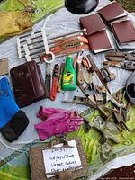 Overview of sandpaper, tools, gloves, planner, glue and vintage cabinet hardware