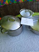 All three pots with lids displayed on table