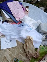 pile of assorted fabric pieces on table