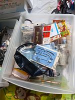 Tray with packaged needles, hooks, snaps, pleater attachments and other small notions