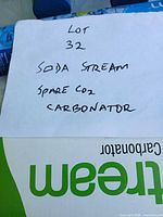 Note identifying lot and partial view of boxed CO2 cylinder