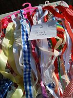 Pile of multicolored fabric strips with note Lot 30 Sewing Stripes