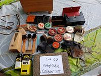 Overview of entire lot laid out showing box, polish tins, brushes, bottle, polisher, cloths