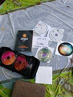 Group of Zumba Gold box, loose Zumba discs and Bones discs in zip wallet