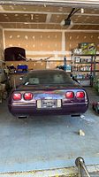 Rear exterior view of purple 1993 Corvette in garage