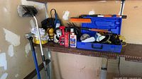 Shelf with compressor case, polishers, liquids, brushes, pads visible