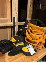 Group shot showing all DeWalt tool bags, knee pads and belt