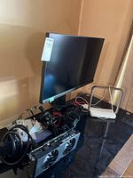 Overall lot showing Acer Predator monitor, GeForce RTX card, charging station and cables