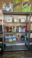 Full view of gray metal shelving unit with five shelves
