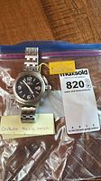 Watch in plastic bag with Invicta tag and lot card visible