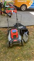 Full view of Milwaukee cordless lawn mower with bag and discharge plug