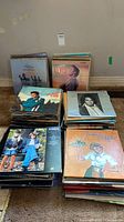 Stacks of vinyl record albums showing Elvis, ABBA, American Graffiti covers