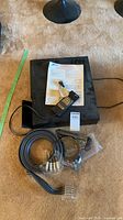 Top view of Zenith VR3200 unit with manual, remote, cable bundle