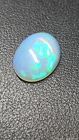 Oval crystal opal on textured background