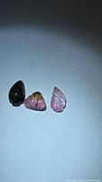 All three leaf-cut tourmaline gemstones grouped together