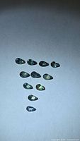 Top view of 11 pear-cut sapphires showing color variation