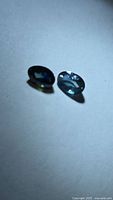 Pair of oval sapphires showing color difference