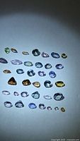 Group of loose multicolored Tanzanite stones under spotlight