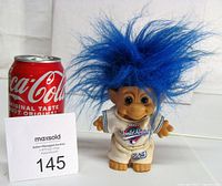 Front view showing entire troll doll with blue hair, uniform, size comparison