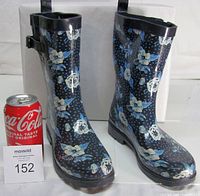 Pair of boots beside soda can for scale, showing exterior pattern and height