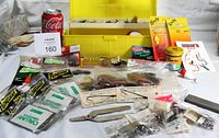 Overall lot view showing yellow tackle box open, packaged tackle and tools