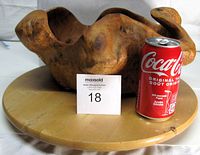 Burl wood bowl on lazy susan beside soda can for scale