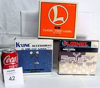 Front view of three product boxes: Lionel Classic Street Lamps #71, K-Line Twin Lampposts, Lionel Road Signs, soda can for scale