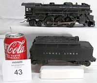 Side view of Lionel 2026 locomotive next to Coca-Cola can for scale, tender in foreground