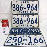 All four Ontario license plates with can for scale