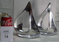 Front view of both sailboat sculptures with scale reference