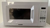 Front view of Comfee microwave showing door, window, and keypad