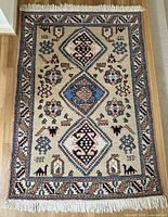 Full view of rug showing pattern, colors, fringe