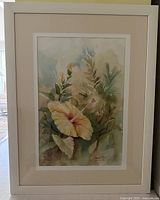 full view of watercolor painting in frame showing yellow hibiscus subject