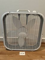 Front view of Lasko box fan showing grille and blades