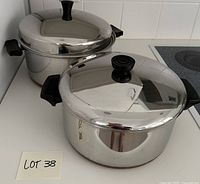 Both Revere Ware stock pots with lids on countertop