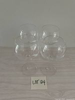 Four clear stemmed coupe glasses front view