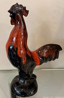 Full view of rooster figurine, left profile