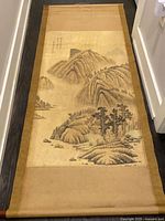 Full view of scroll laid flat showing entire artwork and mount