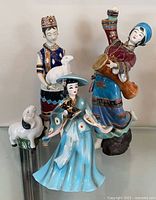 Group shot of all four porcelain figurines displayed