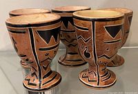 Front and side views of five redware goblets