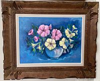 Full view of framed oil painting showing floral subject and frame style