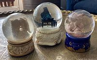 Front view of all three snow globes