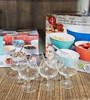 Two boxed bowl sets and six stemmed glasses