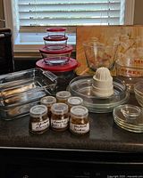 Group shot of all glassware including casseroles, storage bowls, plates, juicer and spice jars