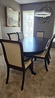 Table shown with chairs (not included) in dining room setting