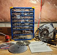 All items together: circular saw, blades, manual, hardware organizer, oil can