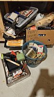 Bins, box and basket containing assorted paint brushes, roller covers, trays, tools