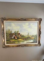 Front view of framed landscape painting on wall