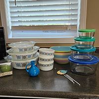 Group view of Pyrex casseroles, bowls, storage bowls, striped bowl and pitcher