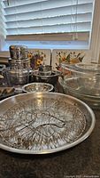 Stainless canisters, prep bowls, frying rack, glass bowls visible